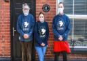 Peter Smith, left, with two of his neighbours who helped him through the crisis, Nadia Hazlehurst from Davies Fish Shop and Digby Eddison owner of Harald’s Chocolates. The tops they are wearing celebrate Clement Attlee, whose government founded the