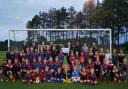 Stalham Youth FC secretary and players receive their grant cheque from Norfolk FA chairman Michael Banham. Picture: Rebecca Burton