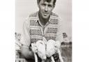 Eric Cook farmed wheat, barley, oats, beans, sugar beet, and potatoes and kept cattle, pigs, and chickens. He is pictured here holding what might possibly be the world's most adorable piglets