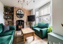 The sitting room has a brick wall and a feature fireplace