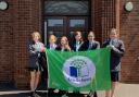 Cromer Academy students with the eco-schools flag