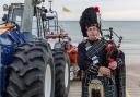 George Sinclair playing the bagpipes outside Sheringham Lifeboat Station