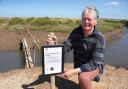 Ian Curtis, Stiffkey resident and bridge campaigner, with the sign put up by the National Trust at the 'fairy bridge'