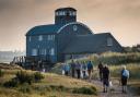 Clean-up volunteers head back to the Lifeboat House at Blakeney Point at the end of the day