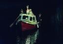 Santa and his helpers arriving by boat at Cley in north Norfolk