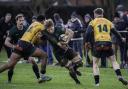 Charlie Fethany rides out a high tackle in the North Walsham game against Bury St Edmunds