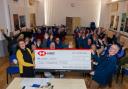 Cromer Peregrine Project chairman Eddie Anderson presents a cheque worth £2,000 from the group to Cromer's Parish Church