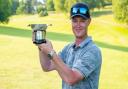 Brad Smith with the English Open for golfers with a disability trophy.