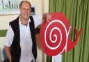 Patrick Prekopp with the Slow Food Aylsham snail logo on a sign.