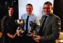 Holt Farmers' Club's double malting barley champion Andrew Ross (centre), with judge Rebecca Gee, grain procurement director for the Crisp Malting Group, and Chris Borrett, of grain merchants Adams & Howling