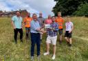 Daniel Salliss (front, right) receiving the ‘biodiversity recognition plaque’ from Mark Allbrook of Cromer Green Spaces