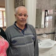 Gail and Ray Westfield, 70 and 73, in front of their damaged bathroom after a car crashed into their home on Harvey Drive, North Walsham, on May 30, 2021.