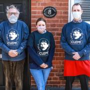 Peter Smith, left, with two of his neighbours who helped him through the crisis, Nadia Hazlehurst from Davies Fish Shop and Digby Eddison owner of Harald’s Chocolates. The tops they are wearing celebrate Clement Attlee, whose government founded the