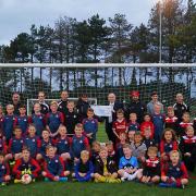 Stalham Youth FC secretary and players receive their grant cheque from Norfolk FA chairman Michael Banham. Picture: Rebecca Burton