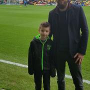 Alfie Oswick with dad Dan at Carrow Road.  Alfie was the community hero who carried out the match ball for the Norwich City game against Ipswich Town.  Pictures: Oswick family