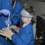 Eight year old Alfie Oswick learns about cancer cells with research scientist Dr Stephen Robinson.  Picture: John Money