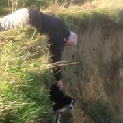 Derek Shaw reaches out to rescue Millie the border collie. Picture: BEVERLEY SALLIS PHOTOGRAPHY