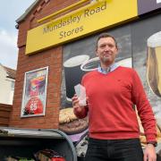 Russ Harmer, who runs two shops in North Walsham, with his 2021 North Norfolk News Business Person of the Year award.