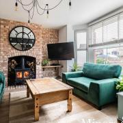 The sitting room has a brick wall and a feature fireplace