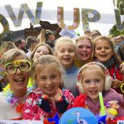 Coltishall Primary School children, staff and parents ready to start their Glow-up Walk along the Bure Valley Railway path to raise funds for Cancer Research, with deputy head Sara Ward, front left.