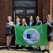 Cromer Academy students with the eco-schools flag