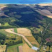 A view of the Horsea Three trench being dug, showing Kelling Heath, the village of Weybourne beyond it, and the north Norfolk coast