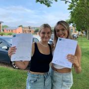 Reepham High School students Ruby Dowe (right) and Mia Starling holding up their GCSE results