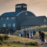 Clean-up volunteers head back to the Lifeboat House at Blakeney Point at the end of the day