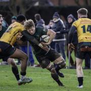 Charlie Fethany rides out a high tackle in the North Walsham game against Bury St Edmunds