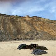 A home in Trimingham on the Norfolk coast is set to be demolished by the council after being left hanging perilously over a cliff edge following a cliff fall