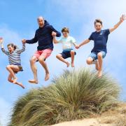 The image, released alongside a message wishing The Prince of Wales a happy 42nd birthday, shows the future king jumping alongside his three children