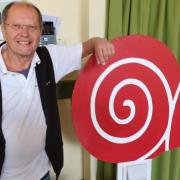 Patrick Prekopp with the Slow Food Aylsham snail logo on a sign.