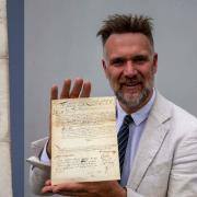 Charles Hanson, owner of Hansons Auctioneers, with the document signed by Oliver Cromwell