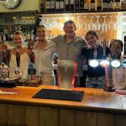 Kate and Matt Starling (centre) and the team at The Dun Cow in Salthouse