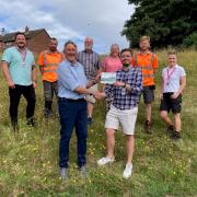 Daniel Salliss (front, right) receiving the ‘biodiversity recognition plaque’ from Mark Allbrook of Cromer Green Spaces