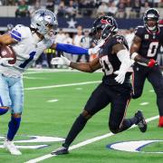 Dallas Cowboys wide receiver Jalen Tolbert, left, puts a stiff arm on Houston Texans safety Jimmie Ward (Gareth Patterson/AP)